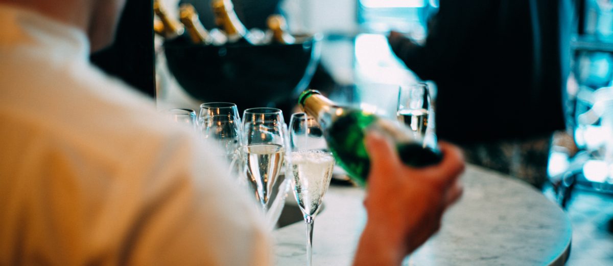 photo of man pouring glasses of champaign